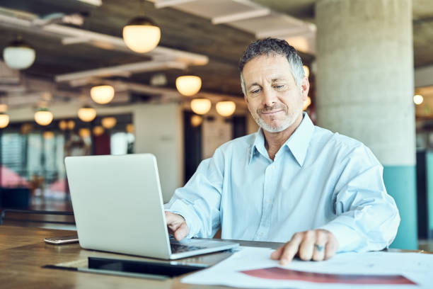istock Mature businessman working at desk in office 1349268416
