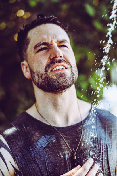 istock Handsome fit young guy showers outdoors after trip to the beach 1349269584