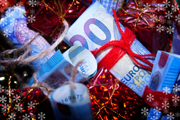 istock Money in a Christmas gift tied with red thread 1349272136