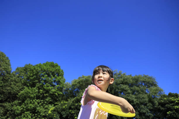 istock Japanese student girl playing flying disc (6 years old) 1349275221