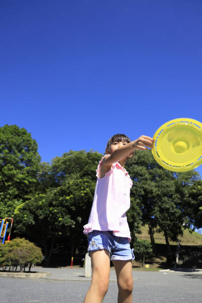 istock Japanese student girl playing flying disc (6 years old) 1349275258