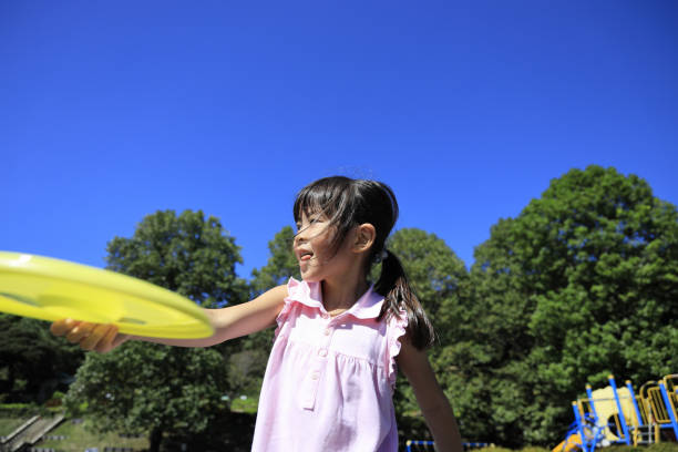 istock Japanese student girl playing flying disc (6 years old) 1349275268