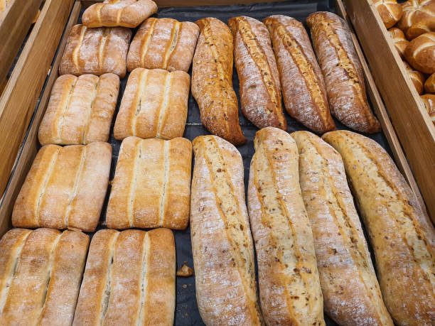 istock Different types of baguettes and buns in a bakery 1349275838
