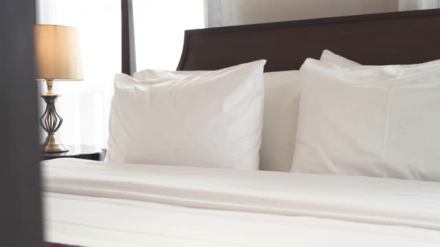 Double pillow and bed at the hotel bedroom interior