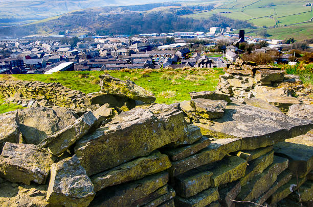 Overlooking the Lancashire Town of Rawtenstall which a thriving industrial and mill Town. This view is down the Rossendale Valley from the Lancashire Moors. Moss Covered Drystone Wall built without cement that lasts for hundreds of years in Lancashire England lancashire stock pictures, royalty-free photos & images