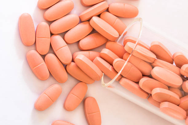 istock Women's Daily Vitamins Spilled from a Jar 1349278938