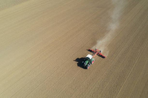 istock Tractor working in field, aerial view 1349279143