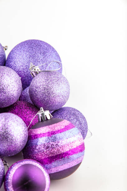 istock Purple glittered baubles on white background 1349279211