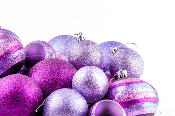 istock Purple glittered baubles on white background 1349279214