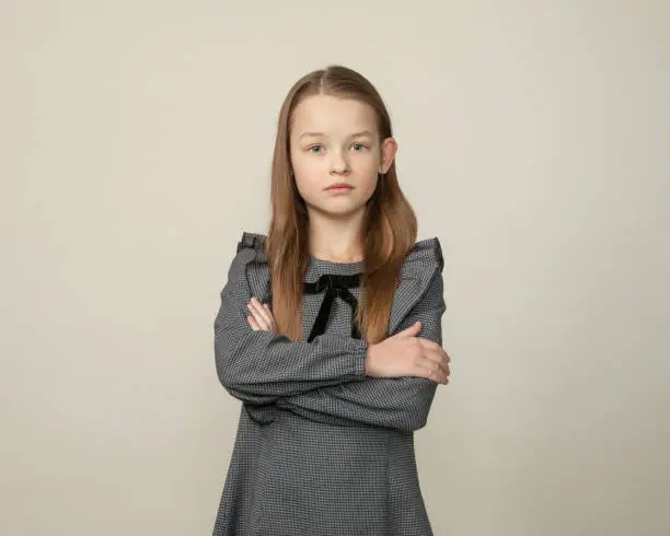 Photo of Close up studio portrait of 9 year old girl on gray background