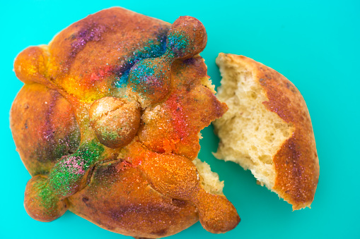 Colorful Pan de Muerto/Day of the Dead Bread on Turquoise Background