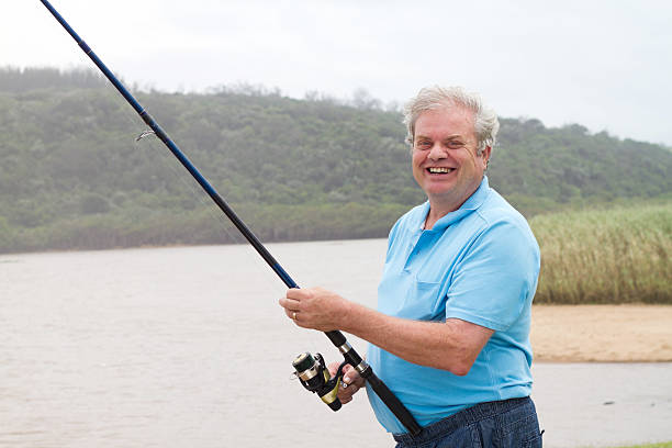 istock happy senior man fishing 134928094