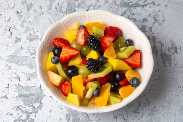 istock Dietary fruit salad with fresh summer fruits 1349283625