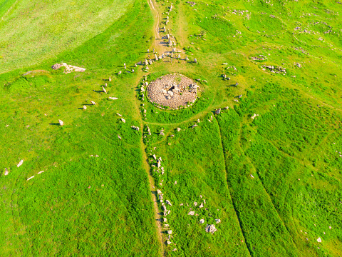 Large stones in a field with round holes in Karahunj - Armenian Stonehenge, Zorats Karer, Armenia top view