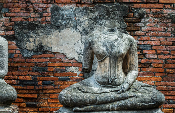 istock Ancient old buddha statue sculpture is damaged at the old temple in Ayuthaya. 1349287745