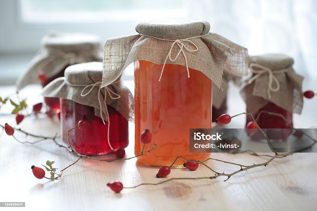 Autumn canning Autumn canning: jars with jam on a wooden table Preserves Stock Photo