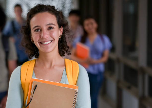 istock Happy female student smiling at the university 1349298015