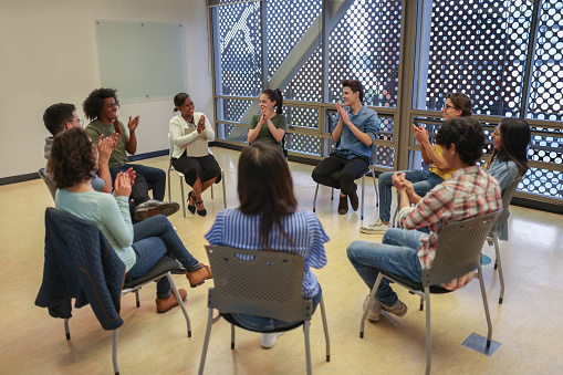 Successful therapy session for a group of Latin American college students seeking counseling at school - education concepts