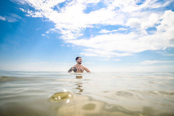 istock Man swimming in idyllic blue ocean 1349298750