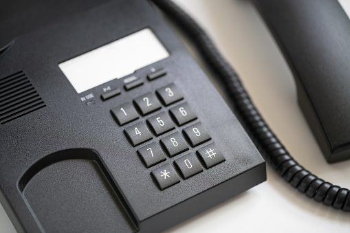 Close-up phone on the desk in the office, working concept as a network operations center