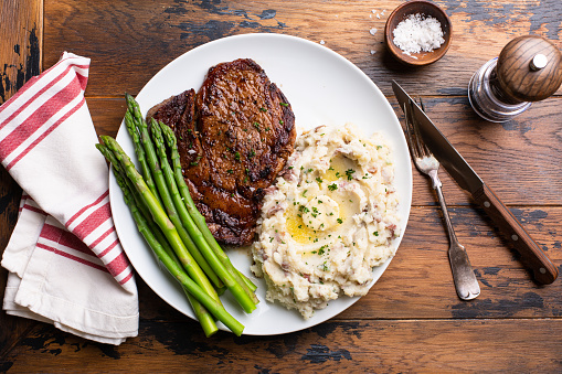 Traditional steak and mashed potatoes with blanched asparagus
