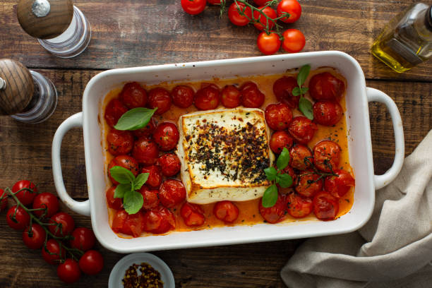 istock Baked feta cheese with cherry tomatoes in a pan 1349299918