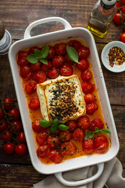 Baked feta cheese with cherry tomatoes in a pan