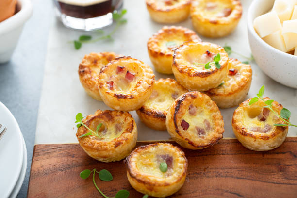 Mini ham and cheese quiches for breakfast Mini ham and cheese quiches freshly baked ready to eat quiche stock pictures, royalty-free photos & images