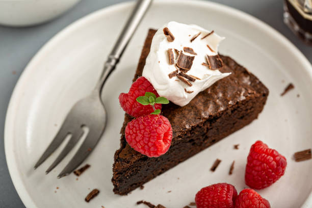 istock Brownie cake topped with fresh raspberries 1349299948