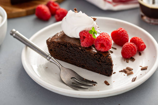 istock Brownie cake topped with fresh raspberries 1349299956