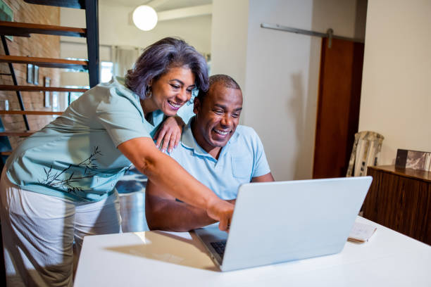 istock Mature couple using laptop at home. 1349300730