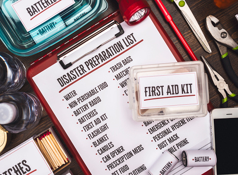 Disaster Preparation Kit Flatlay with Items on Gray Table