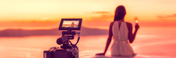 Videography professional video camera shoot behind the scene shooting at hotel filming sunset scene banner panorama, luxury travel. Professional videography equipment shooting in summer destination. stock photo