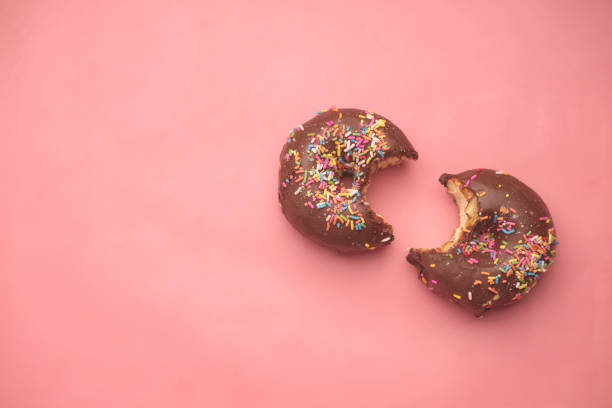 istock top view of half eaten chocolate donuts on pink 1349301566