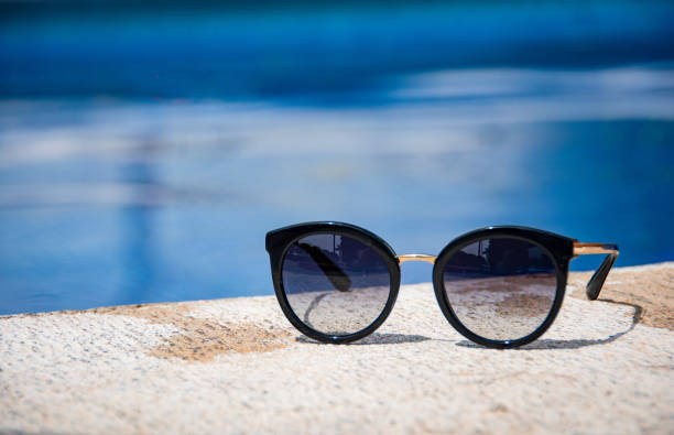 istock Sunglasses at the edge of a pool 1349301858
