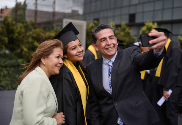 Graduate student taking a selfie with her parents on her graduation day