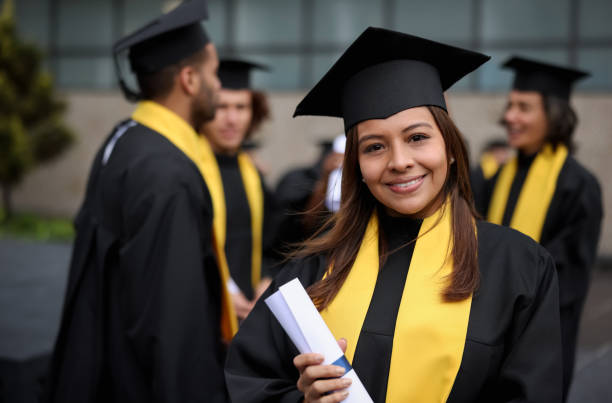 istock Happy graduate student holding her diploma on her graduation 1349302568