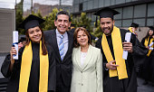 istock Graduate students smiling with their parents on their graduation day 1349302590