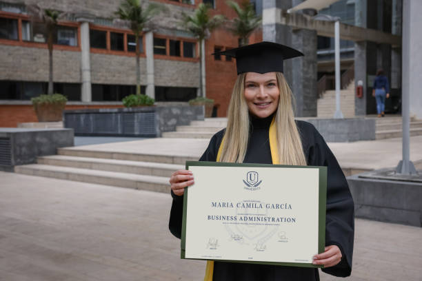 istock Happy graduate student holding her diploma in business administration 1349302601