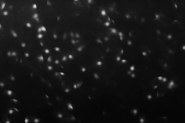 Defocused Black friday bokeh background. Elegant dark blurred layout design. Silver and black glitter spotlight. Luxury abstract banner with copyspace