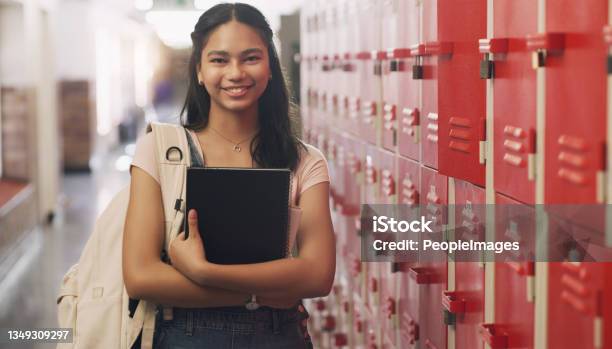 Portrait Of A Teenage Girl Standing Next To His Locker At High School Stock Photo - Download Image Now