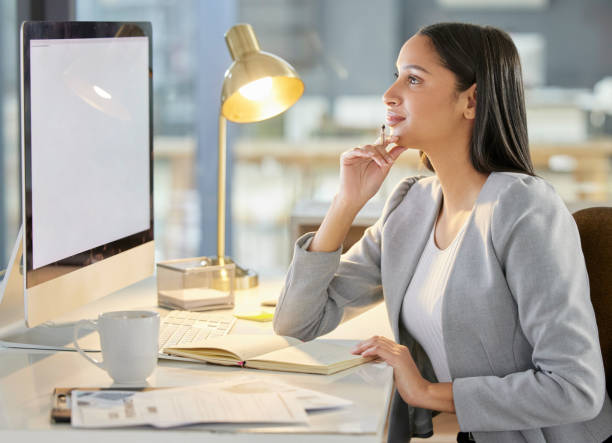 istock Shot of a young businesswoman using a computer in a modern office 1349311086