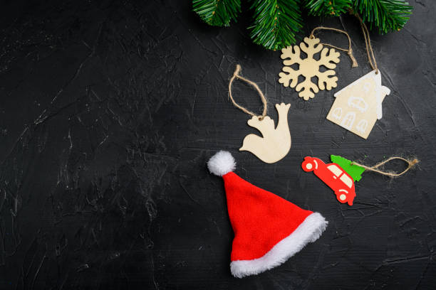 istock Christmas decorations and objects, wooden toys, top view flat lay, on black dark stone table background, with copy space for text 1349312670