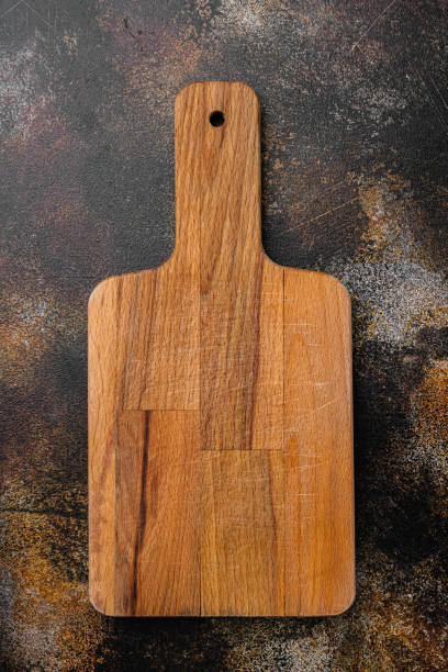 istock Wooden cutting board, on old dark rustic table background, top view flat lay , with copy space for text or your product 1349314466