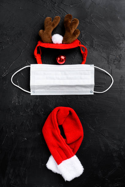 istock Year 2022 with Surgical Face Mask and deer, on black dark stone table background, top view flat lay 1349314638
