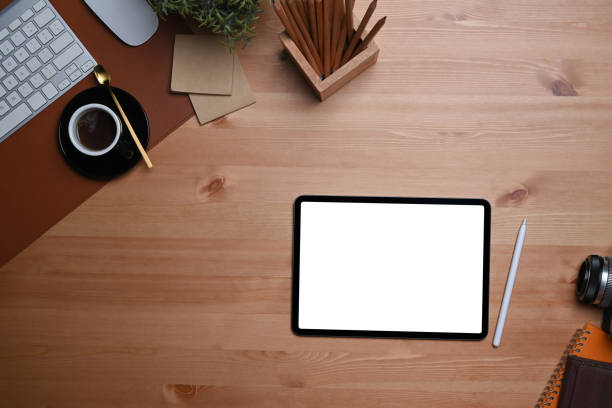 istock Top view digital table, stylus pen and coffee cup on wooden tale. 1349314689