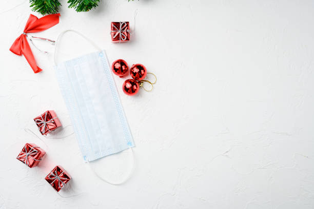 istock Christmas decorations decorative with face mask covid, on white stone table background, top view flat lay, with copy space for text 1349316409
