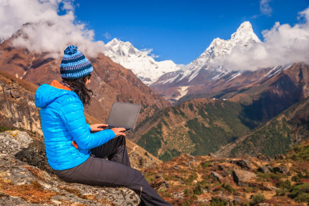 istock Young woman using laptop in Himalayas, Nepal 1349317907