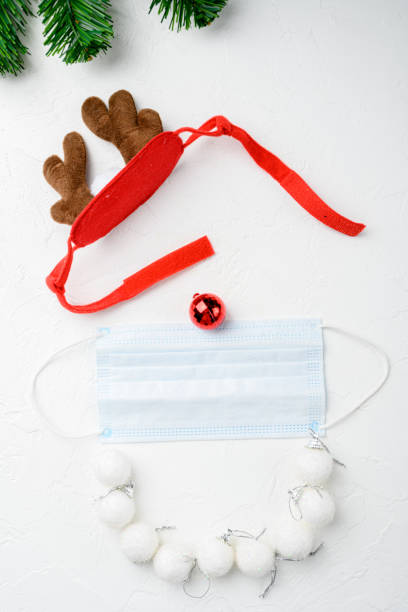 istock Year 2022 with Surgical Face Mask and deer, on white stone table background, top view flat lay 1349317935