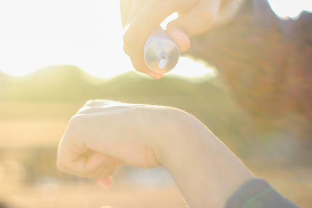 istock young women using sun screen care outdoor 1349318917